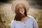 Stylish girl in rustic dress smiling and waving hair in sunny meadow in mountains. Portrait of happy boho woman in countryside at