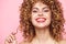 Stylish girl Wide smile with curly hair bright makeup background