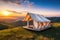 Stylish glamping tent in mountains at sunset. Generative AI