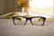 Stylish glasses closeup and blured book.