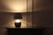 Stylish glowing night lamp on table in room. Space for text