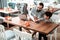 Stylish good-looking father and son sitting at the table in restaurant