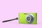 Stylish greeb compact pocket digital camera isolated on pink background