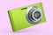 Stylish greeb compact pocket digital camera isolated on pink background