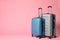 Stylish grey and blue suitcases on background. Space for text