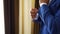 Stylish groom in blue luxury suit wearing cufflinks close up