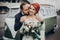 Stylish groom gently kissing his happy bride in neck at retro car and smiling. emotional romantic moment, space for text. luxury