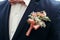 Stylish groom or groomsmen in suit with pink roses boutonniere a