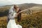 Stylish groom kissing gorgeous bride in sun light, perfect mome