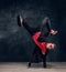 Stylish guy performs breakdance acrobatic elements.