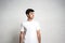 Stylish guy in white blank t-shirt, horizontal studio portrait,