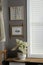 Stylish hallway interior with bamboo frame on grey wall