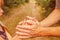 Stylish hands of a parent and child in the nature in a park background