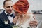 Stylish happy bride and groom gently hugging at retro car and smiling. emotional romantic moment, space for text. luxury wedding