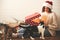 Stylish happy girl in santa hat and her cats opening christmas gift box with magic light in decorated christmas room. Young