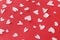 Stylish hearts composition on red background. Valentines day card. Cute little white hearts cut outs on red paper. Happy Valentine