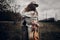 Stylish hipster couple dancing in windy field. boho gypsy woman