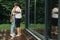 Stylish hipster couple hugging and kissing on wooden terrace, relaxing in cabin in mountains. Happy young family in modern outfits