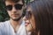 Stylish hipster couple in sunglasses posing and making cool selfie. Happy family couple in love making self portrait and embracing