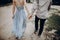 stylish hipster couple walking, holding hands. man and woman embracing, in love relaxing in summer park, picnic date. girl in