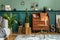 Stylish interior design with retro wooden cabinet, chair, elegant sofa, plants, cube, stool, decoratnion, poster.