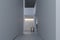 Stylish interior of hallway with firm and geometric lines and forms. Minimalism and constructivism concept. White wall