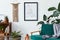 Stylish interior of living room with design wooden shelf, velvet sofa, a lot of plants, mock up poster map, vinyl recorder, book.