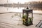 Stylish iron lantern decorated with tropical flowers as a wedding decor on the river bank