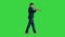 Stylish jazz man walking and playing the trumpet on a Green Screen, Chroma Key.