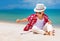 Stylish kid, boy playing with sand on summer beach