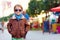 Stylish kid walking city street, autumn fashion