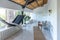 stylish kitchen interior design. white walls and wooden decoration. beautiful hammock and high windows