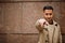 Stylish kuwaiti man at trench coat show finger to camera