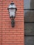 Stylish lantern on red brick wall