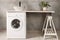 Stylish laundry room with modern washing machine. Interior design