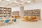 Stylish library interior with bookshelves and relax place with armchairs
