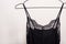 Stylish lingerie. Black nightie hanging on a hanger. Set of female underwear. Advertise or sale concept
