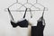 Stylish lingerie. Variety of bra and nightie hanging on a hanger. Set of female underwear. Advertise or sale concept