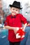 Stylish little boy in a shirt and hat gives gift surprise.Fashionable dandy.