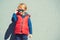 Stylish little boy in sunglasses. Children`s fashion. Funny kid walking city street, autumn fashion. Fashionable boy posing in