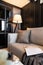 Stylish living  corner with velvet tan color sofa setting with soft pillows with grey spray paint wall on the background, cozy