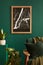 Stylish living room in house with modern retro interior design, velvet sofa, brown wooden furniture, plants, poster mock up map.