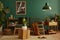 Stylish living room in house with modern retro interior design, velvet sofa, carpet on floor, brown wooden furniture, plants.