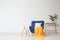 Stylish living room interior with comfortable blue armchair near white wall.