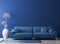 Stylish living room interior in trendy blue, concrete floor with blue sofa. color of the year