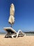 Stylish lounger in yellow sand to sun sunbed on beach in summer under open sky