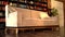 Stylish luxury living room with beige leather sofa and bookshelves in the background