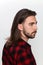 Stylish male model with long hair and beard posing in studio. Modeling, hairstyle, fashion concept.