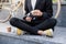 Stylish man in black suit and casual shoes cleaning his reading