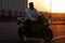 Stylish man on motorbike in evening